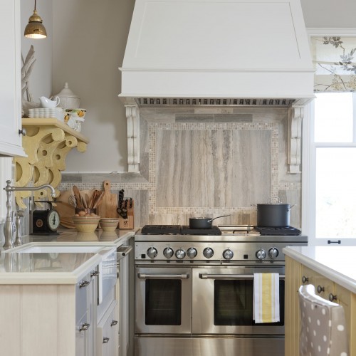 View of stainless steel stove and overhead range